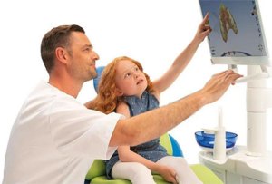 man and child looking at a monitor
