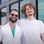 Dr. Austin L. Lyman posing with young male patient outside modern dental office building