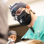Dr. Lyman with patient during surgery