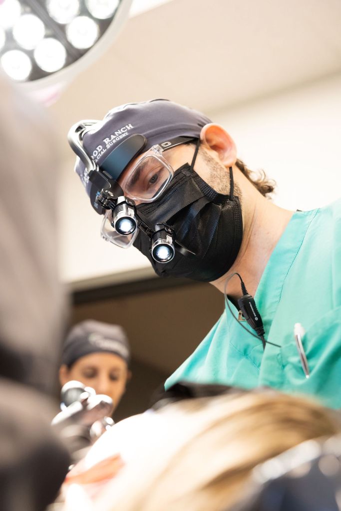 Dr. Lyman with patient during surgery