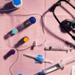 Sterile medical tray with syringes, medication vials, IV supplies, and anesthesia equipment