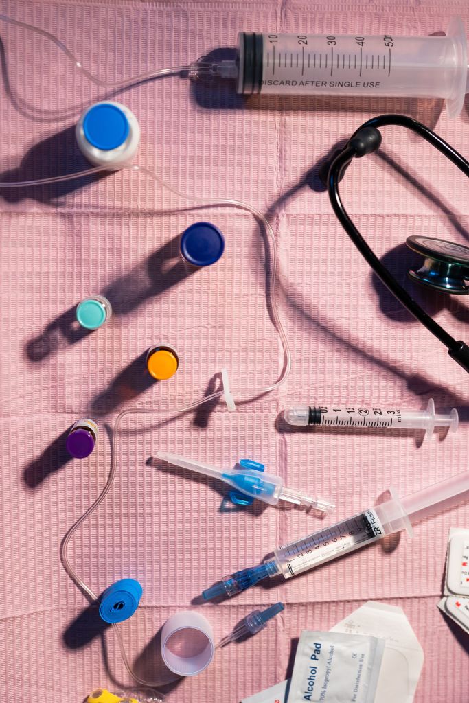 Sterile medical tray with syringes, medication vials, IV supplies, and anesthesia equipment